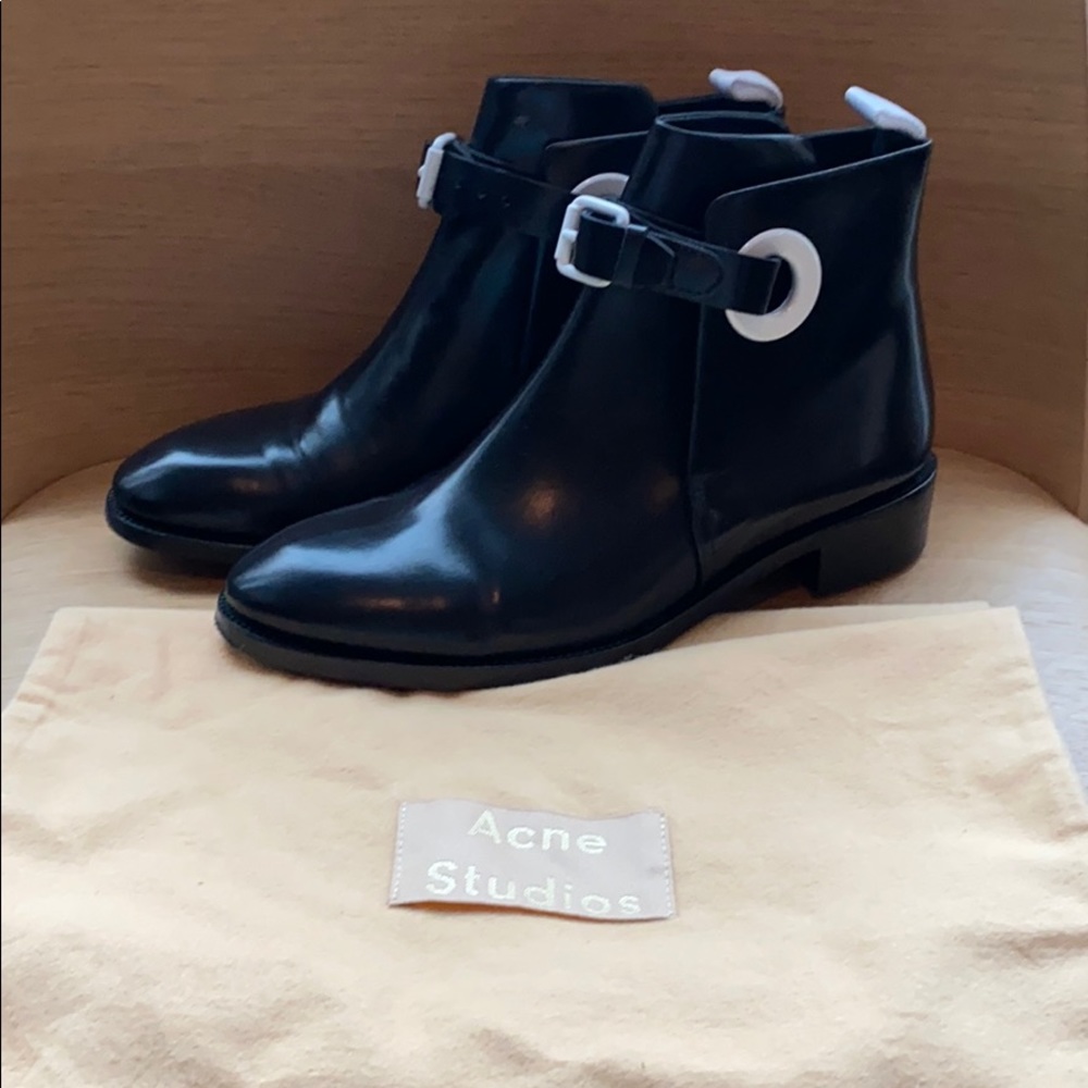 Acne Booties with White buckle accents.